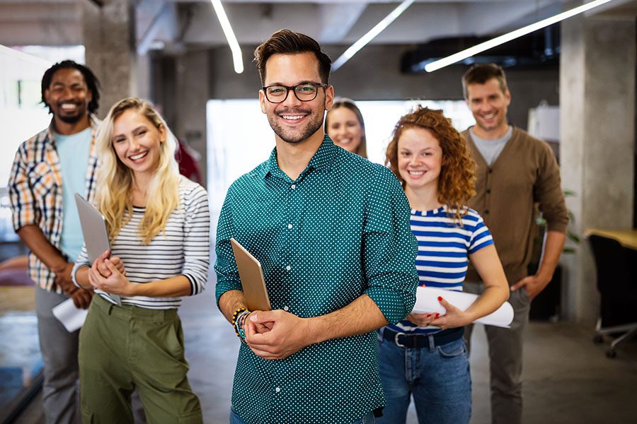 Individual Health Insurance, Health and Benefits - Portrait View of Smiling Successful Business Colleagues in a Modern Office